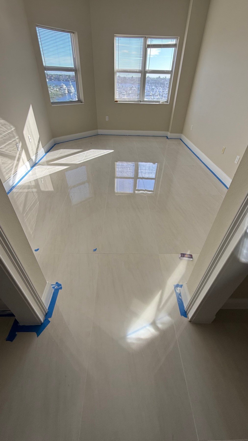 Large-format light floor tile in a finished Sarasota room