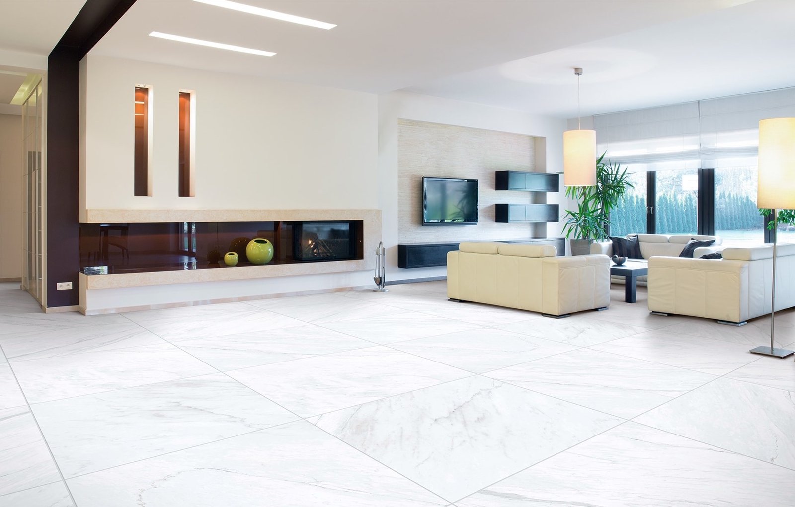 Warm limestone-look tile flooring connecting a Sarasota living room and lanai